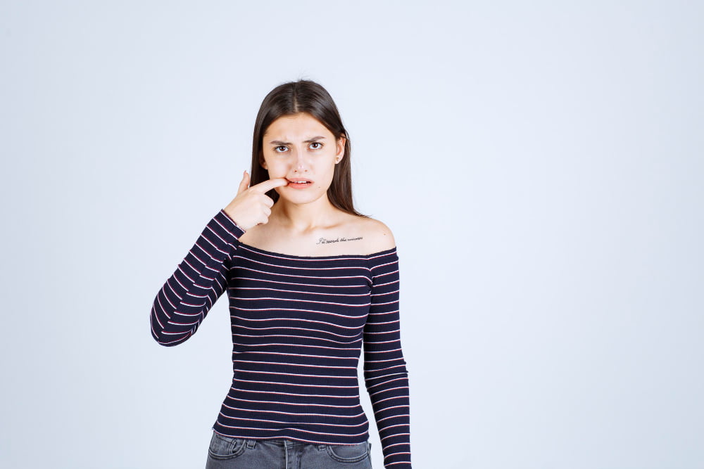 girl srtiped shirt looks ill showing her mouth